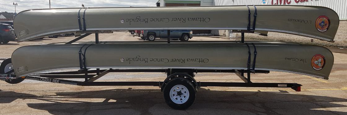 photo of 2 large north canoes on a trailer