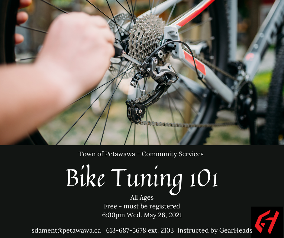 Person tuning up their bike with a screw driver