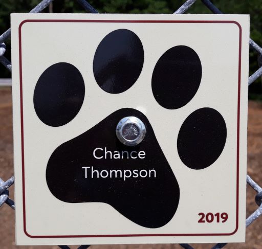 image of dog paw with dog's name and year inscribed