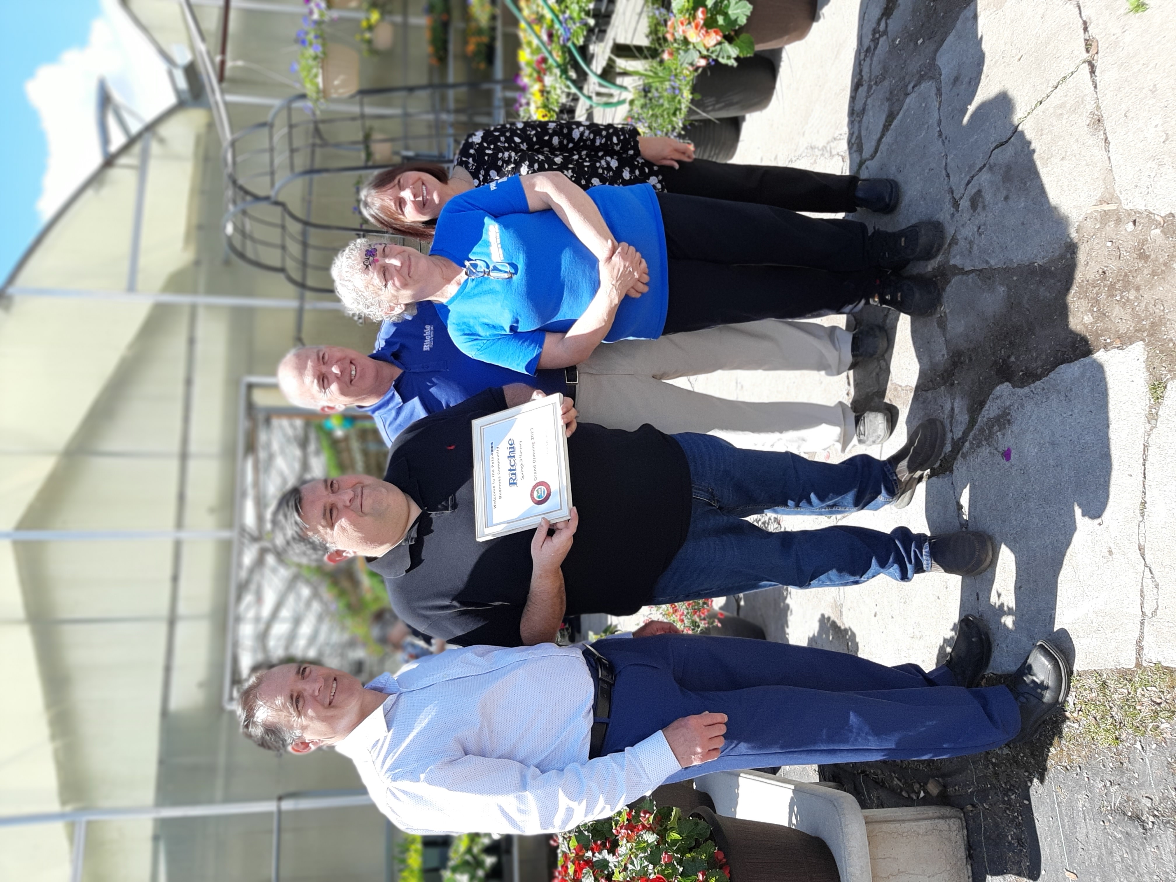 An image of the certificate presentation at the Grand Opening of Richie Feed and Seed