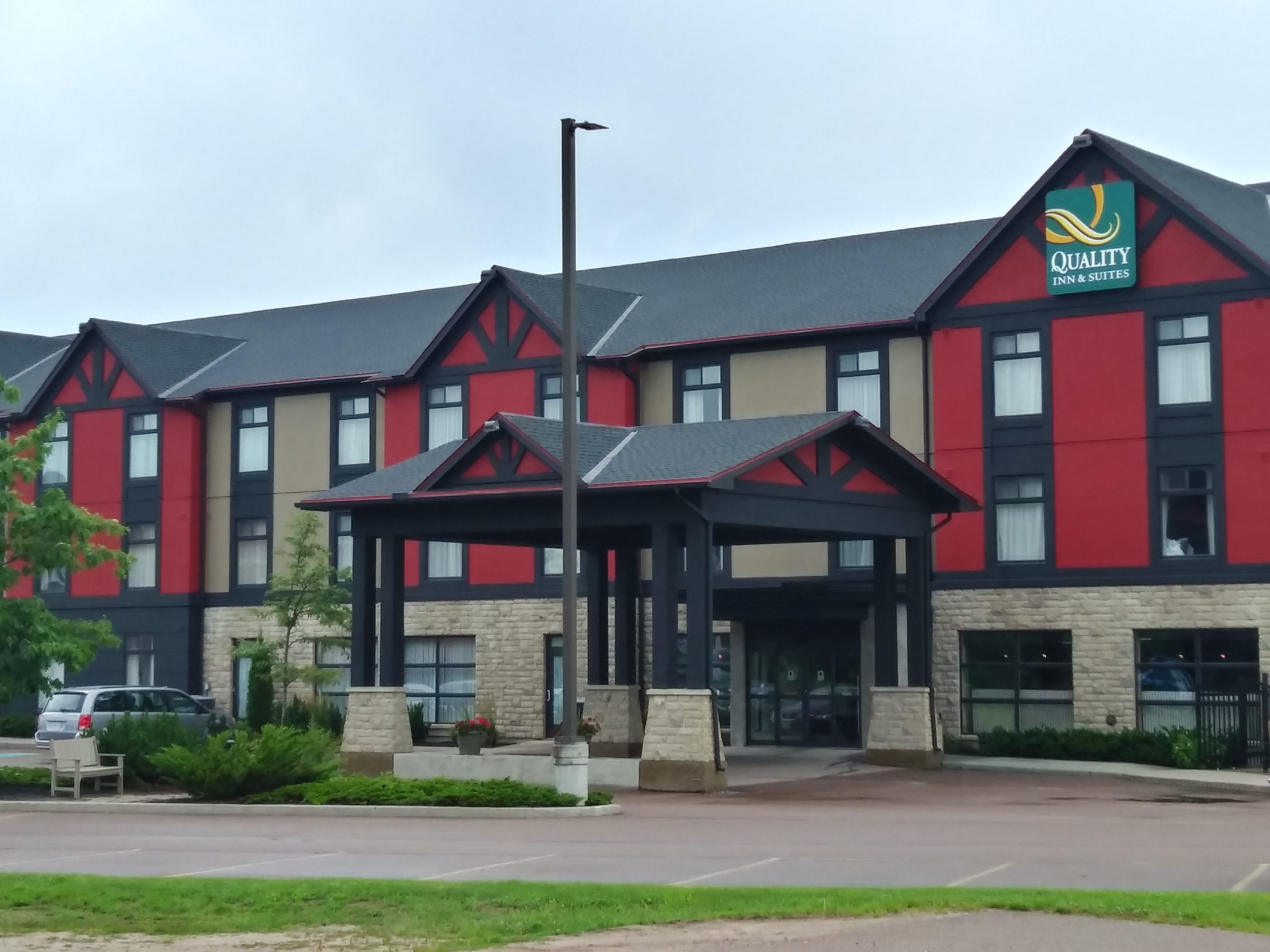 A hotel building painted alternating red and beige accents