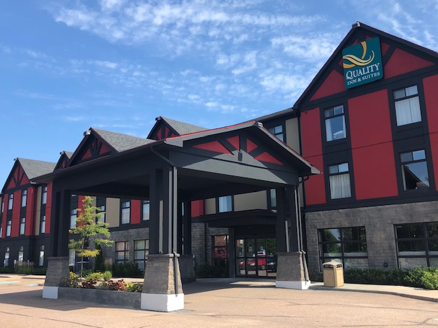 An exterior photo of the Petawawa Quality Inn and Suites, burgundy, black and beige