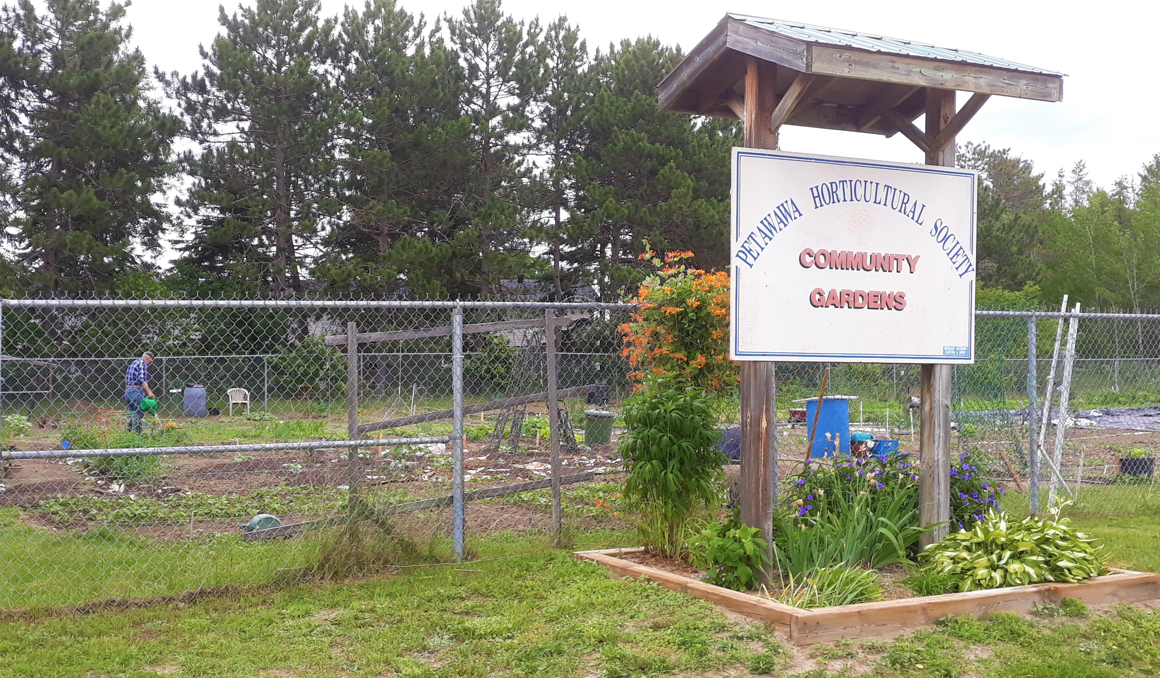 Image of front sign and garden plots at the Community Garden