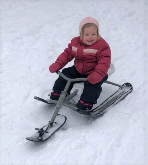 Image of toddler on a GT racer sliding down a hill in winter