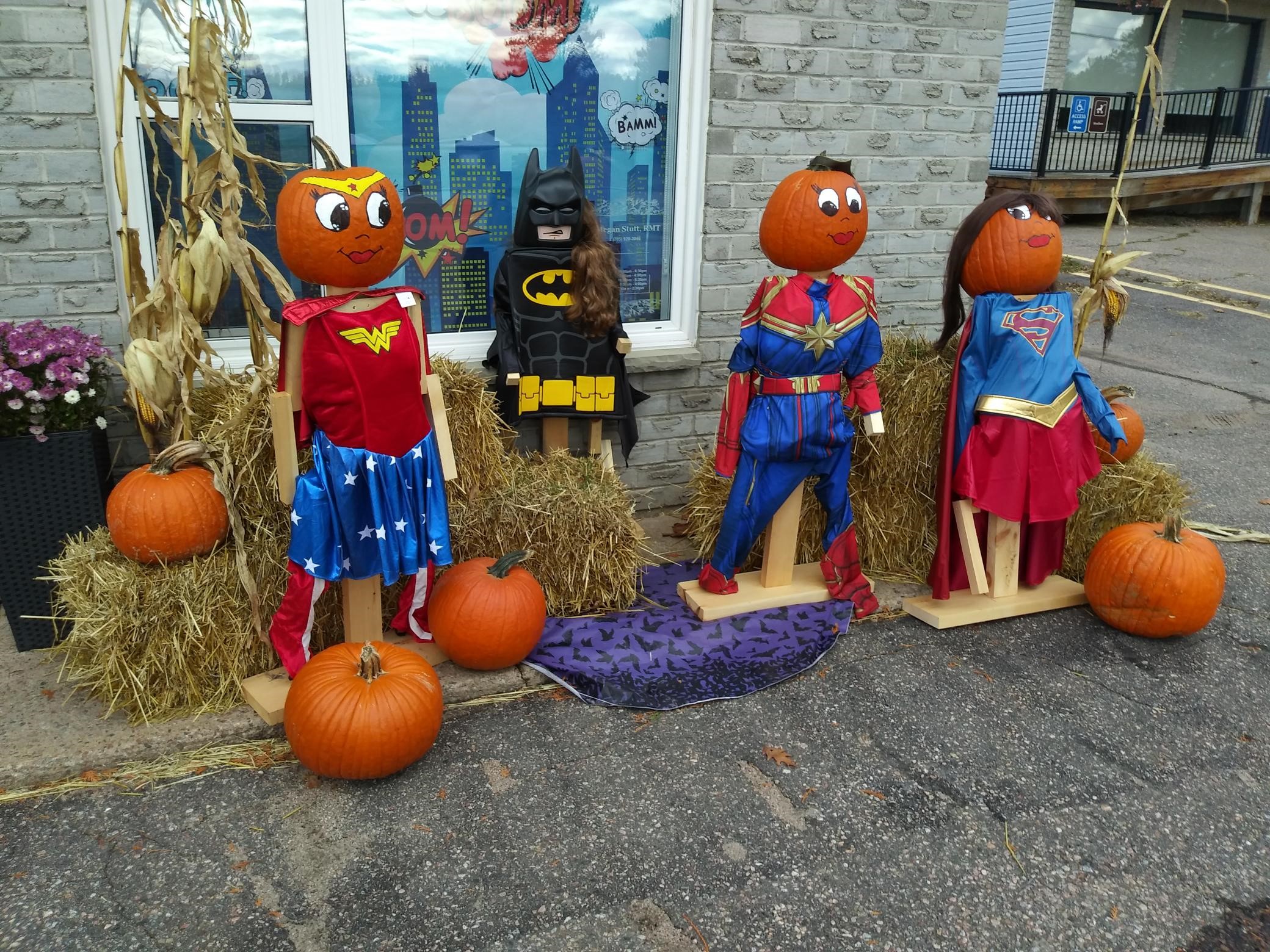 Image of pumpkin folk dressed as super heros
